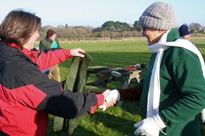 Sandie receiving the waistcoat from the Field Captain, Karen